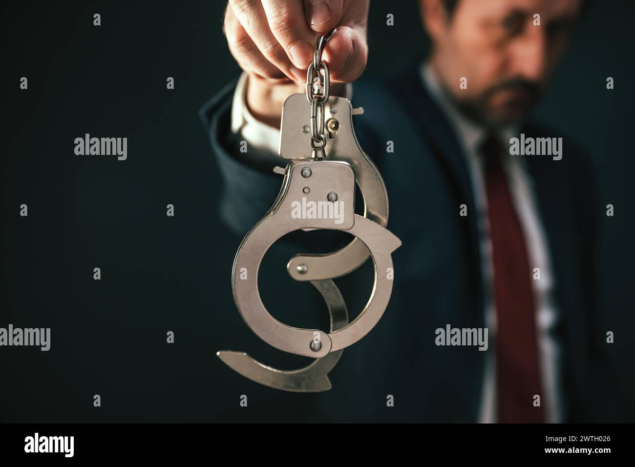 Police detective investigator holding handcuffs during criminal arrest, selective focus Stock Photo
