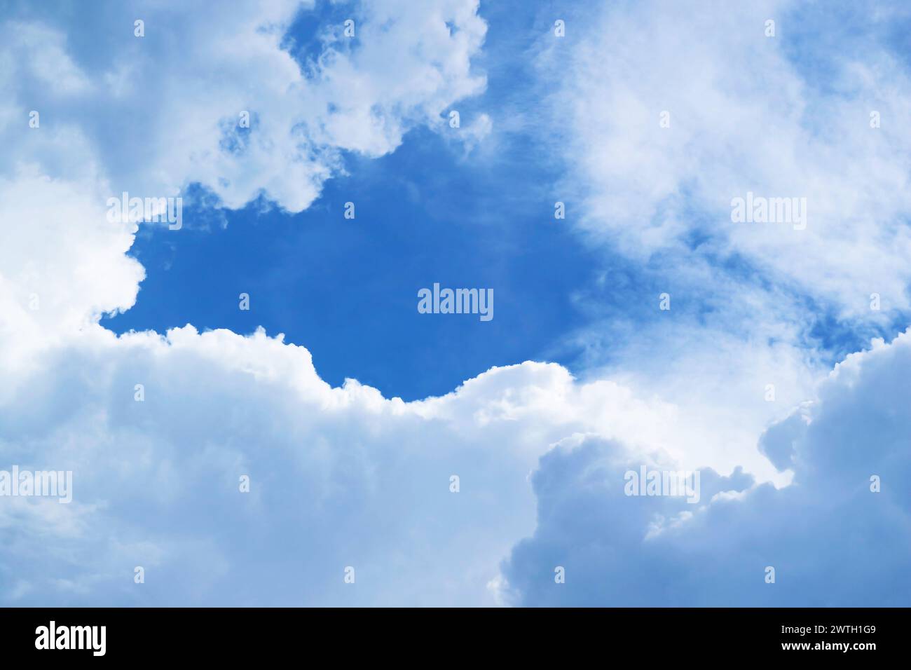 Fluffy White Clouds Forming a Frame on Vibrant Blue Sky Stock Photo - Alamy