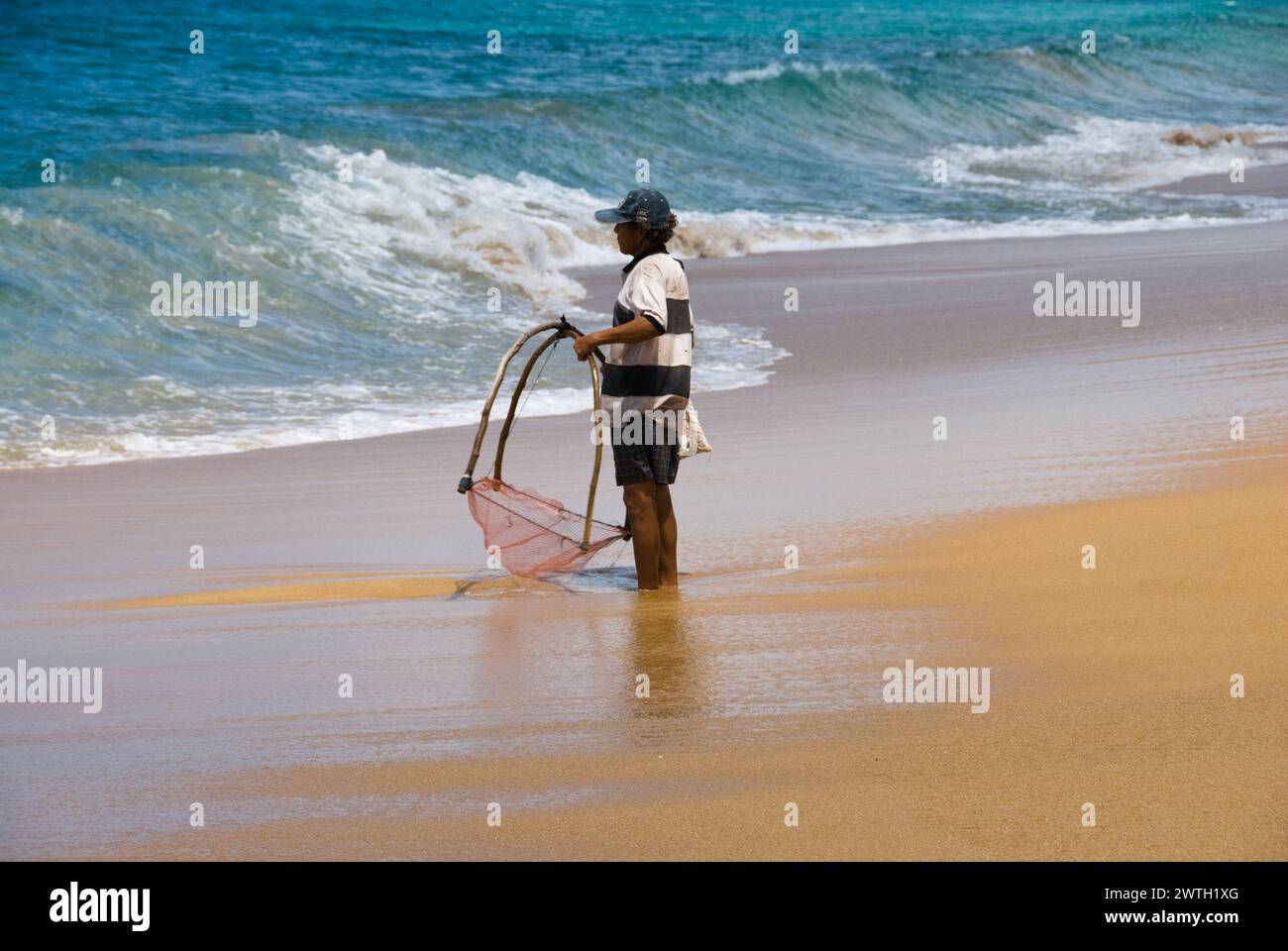 A man fishing with a net in Phuket, Thailand Stock Photo