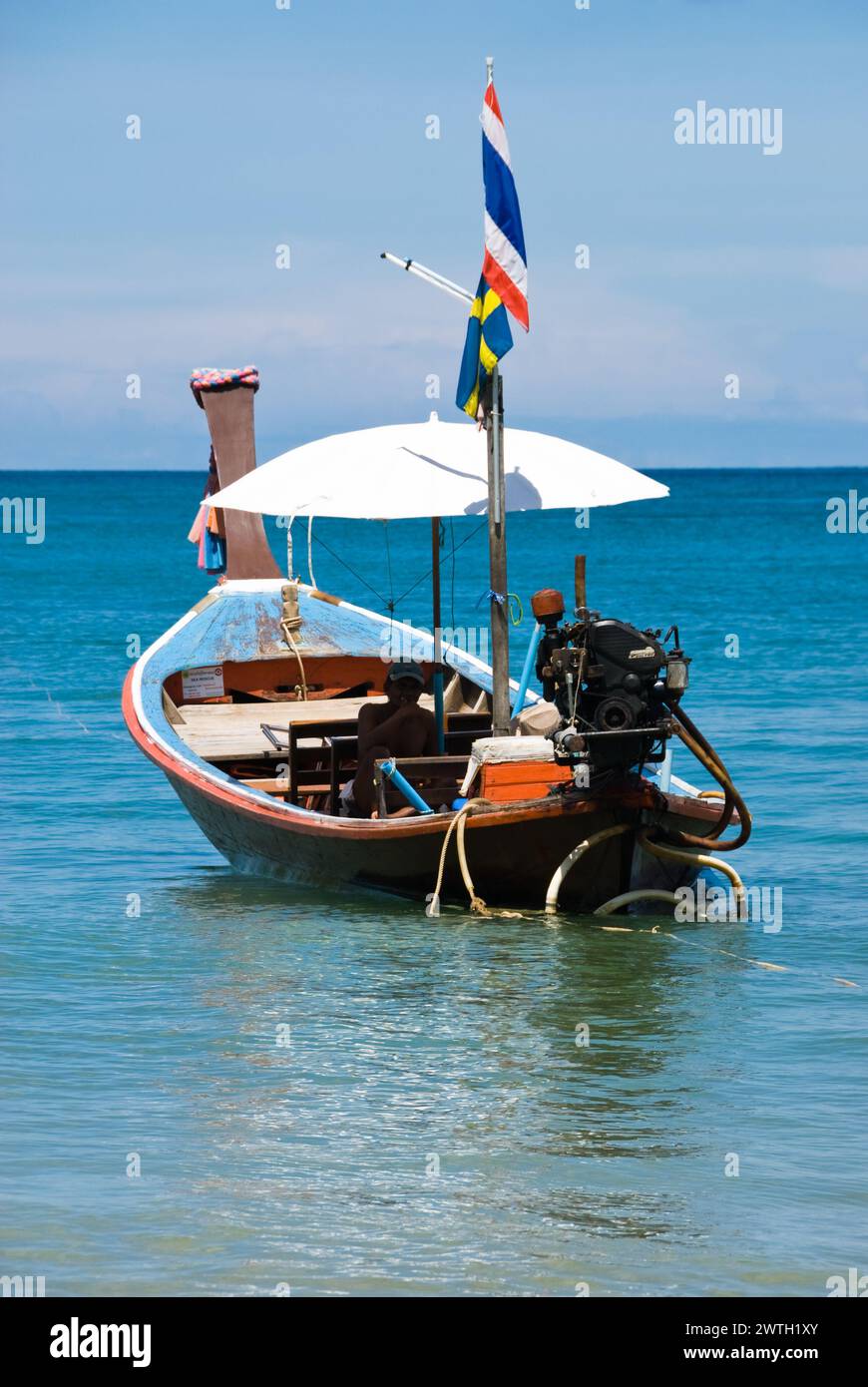 A small boat sails on a sunny day in Phuket, Thailand Stock Photo