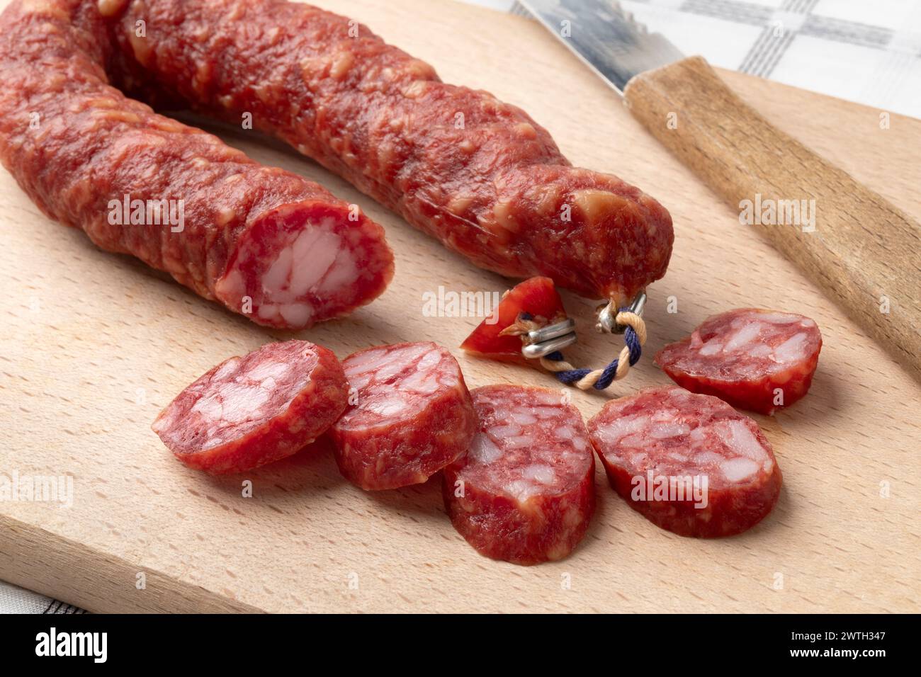 Traditional Dutch Metworst, preserved pork sausage and slices on a cutting board close up Stock Photo