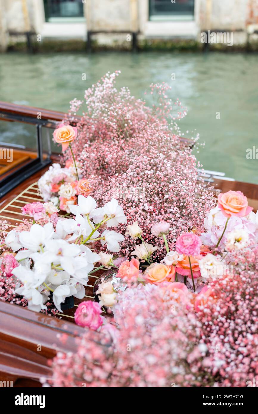 Pink and white florals cover water taxi in Venice Italy Stock Photo