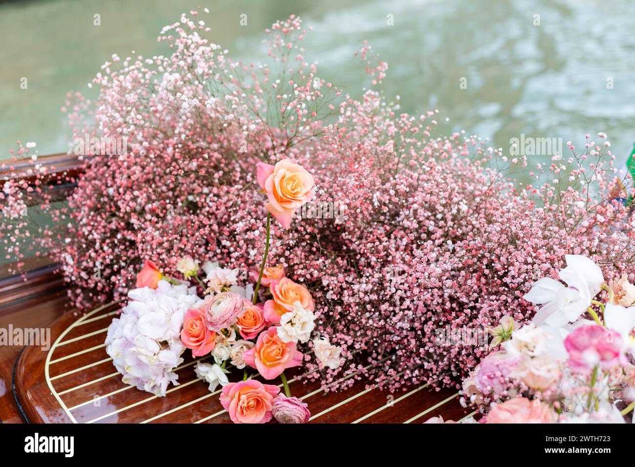 Pink baby's breath flower arrangement on water taxi in Venice Stock Photo