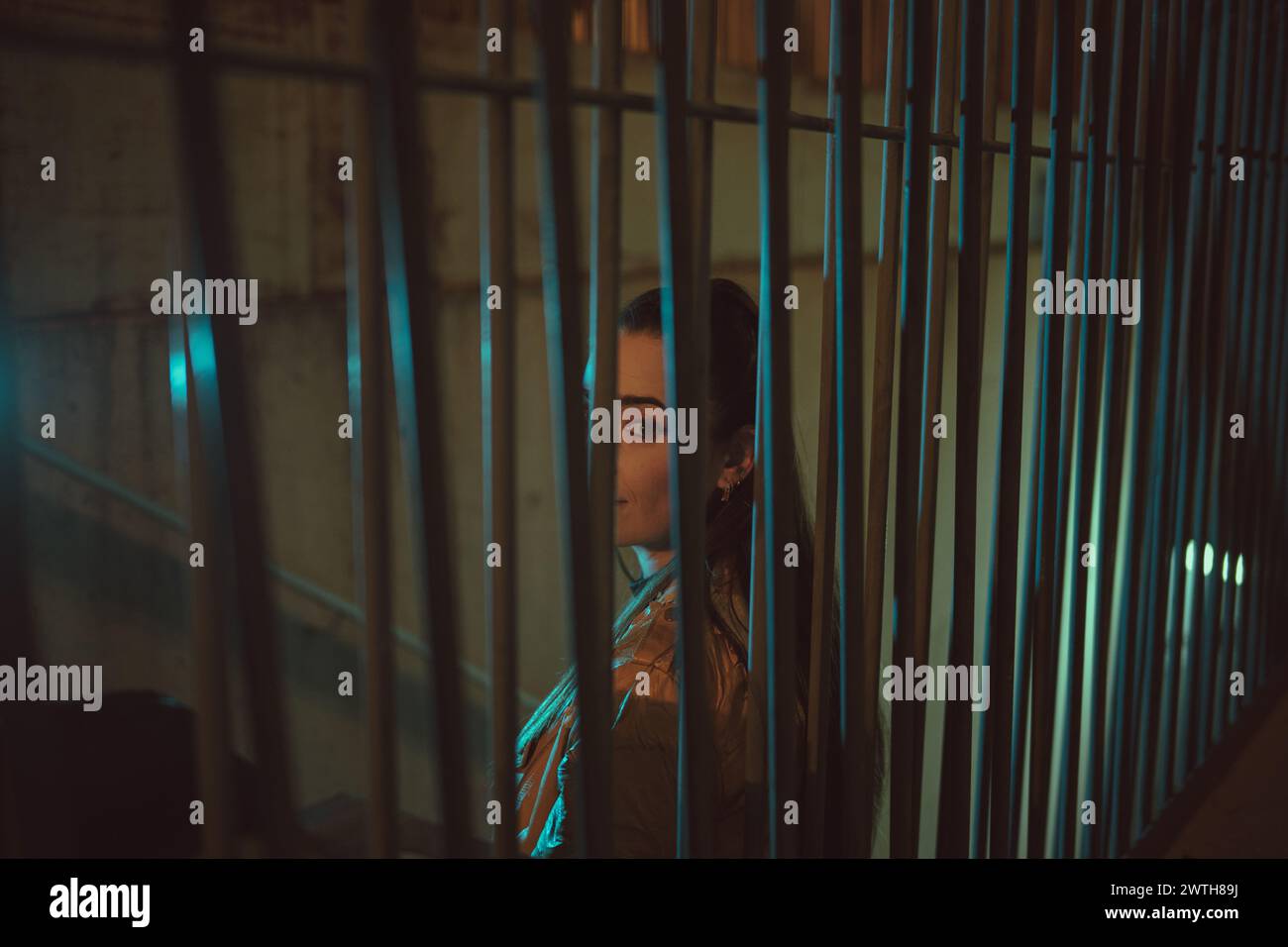 People Standing Behind Railing Mysterious woman standing behind metal railing at night Stock Photo - Alamy