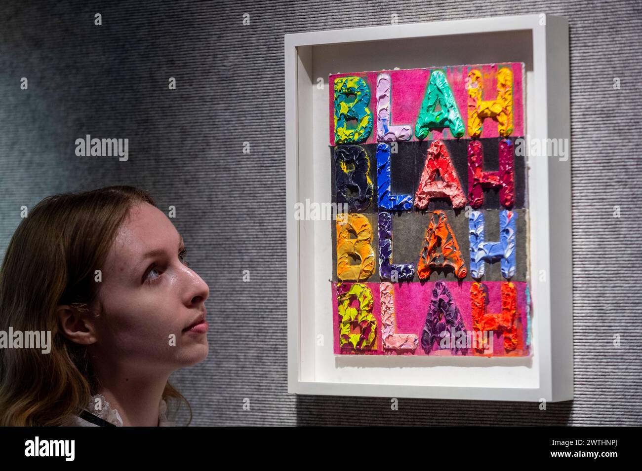 London, UK.  18 March 2024. A staff member with ‘Blah, Blah, Blah (Purple)’, 2013, by Me Bochner (Est. £7,000 - £10,000) at a preview for Bonhams’ Post-war & Contemporary Art sale.  Lots will be auctioned on 21 March at Bonham’s New Bond Street galleries.  Credit: Stephen Chung / Alamy Live News Stock Photo