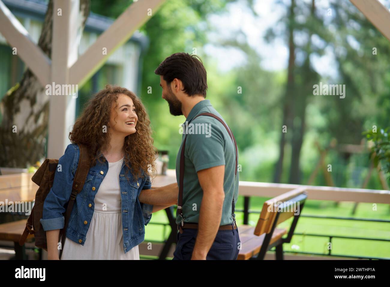Friends meeting at a restaurant terrace. Greeting, hugging, after long