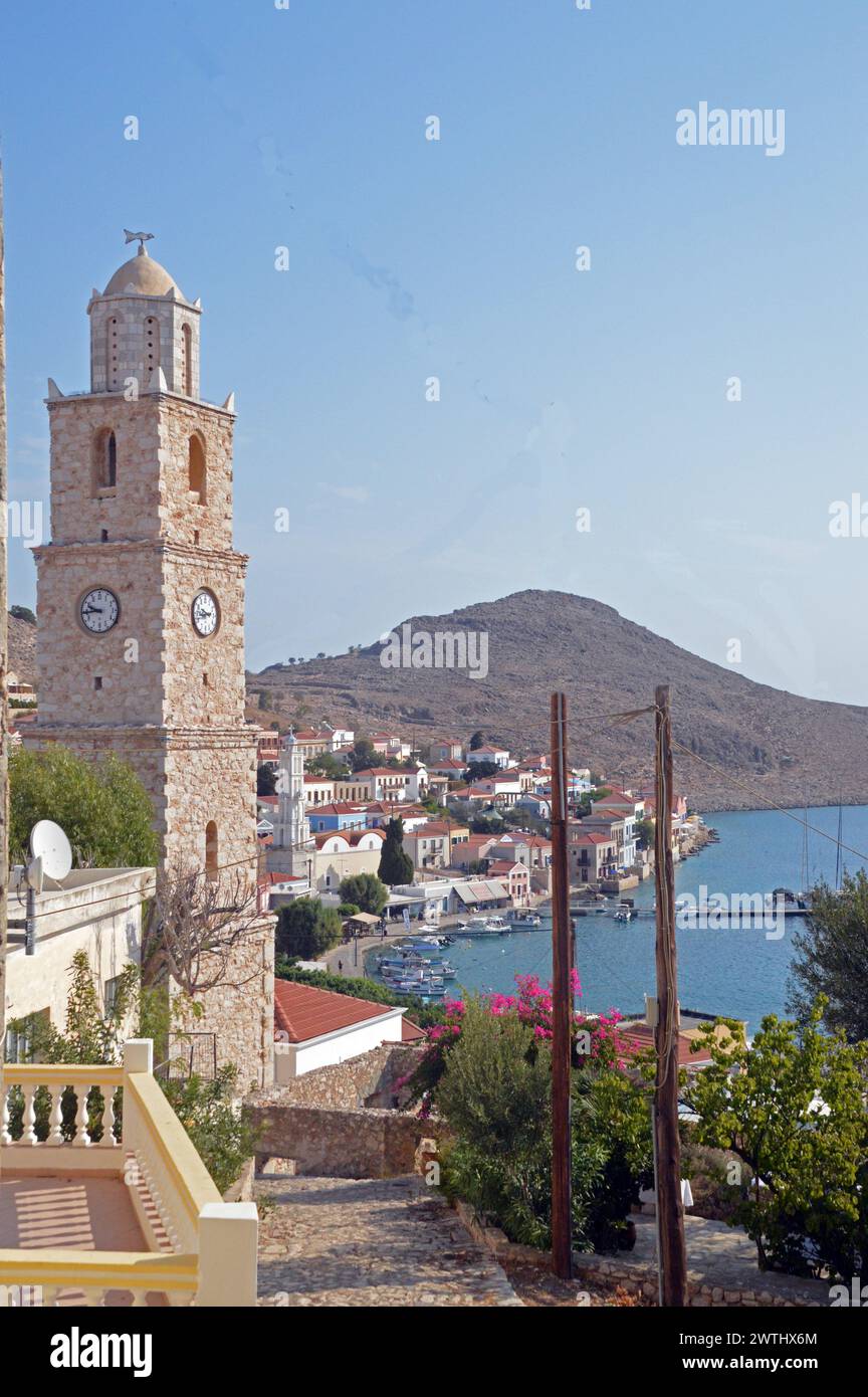 Greece, Island of Chalki:  view of the town and waterfront, with one of the belltowers in the foreground. Stock Photo