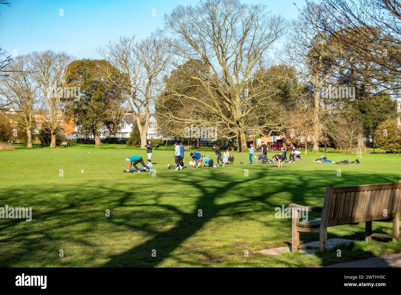 A group of people exercise together on a Saturday morning in early spring in Marble Hill Park in Twickenham, Surrey Stock Photo