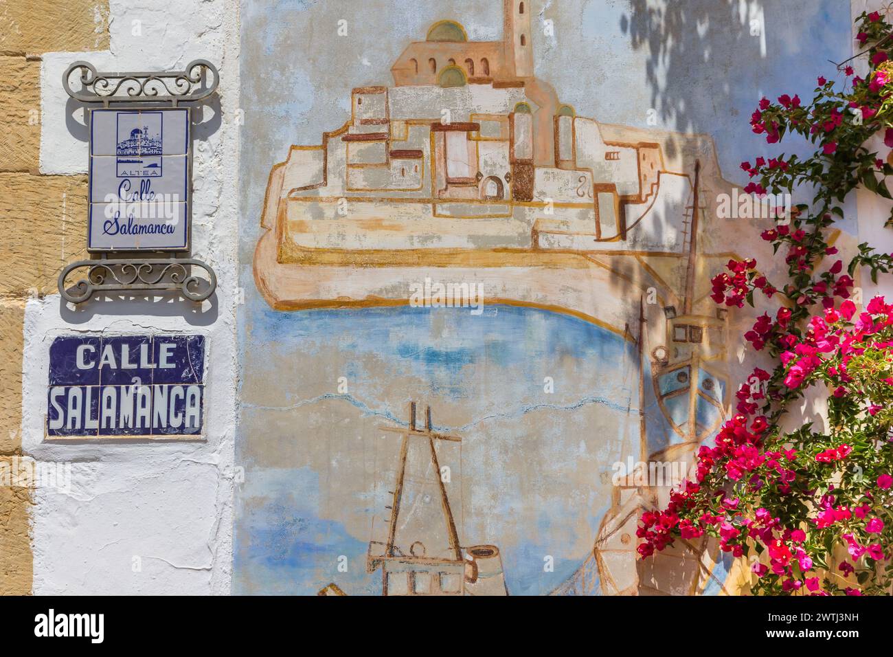 Street sign, mural and pink flowers in the historic town of Altea ...