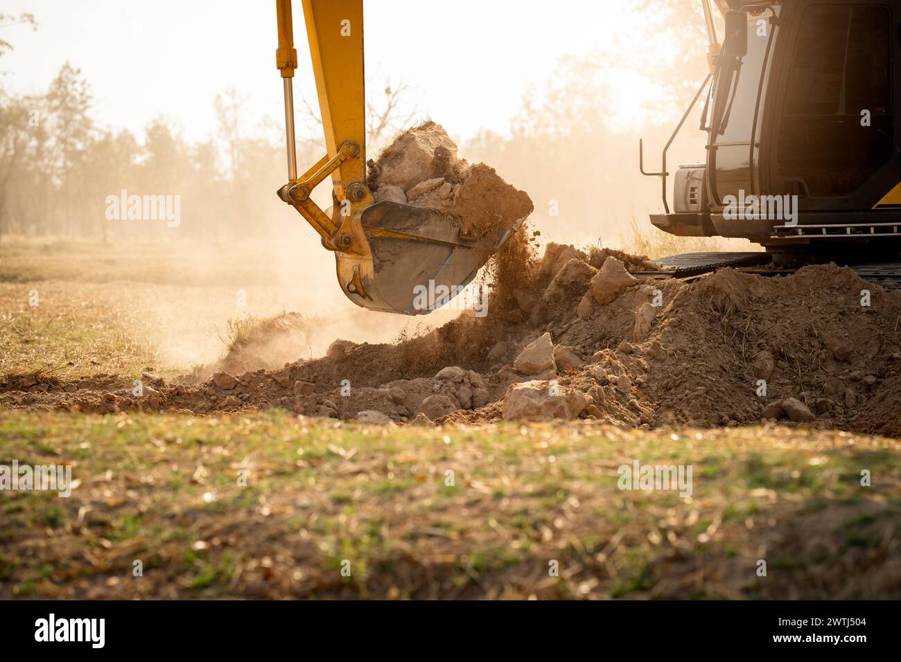 Backhoe working by digging soil at construction site.  Crawler excavator digging on demolition site. Excavating machine. Earth moving machine. Excavat Stock Photo