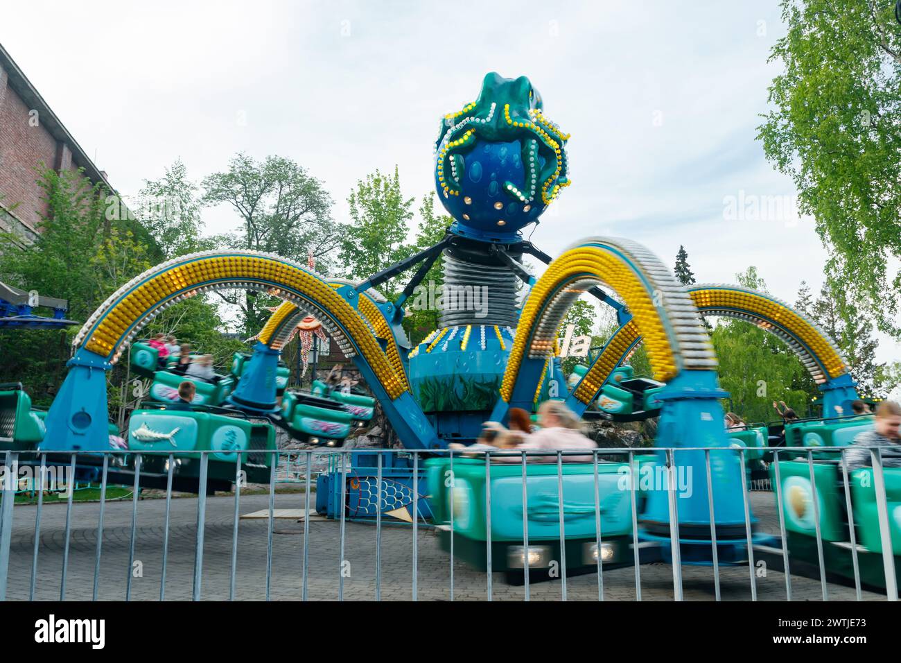 Helsinki, Finland - 21 May 2023: Carousel Mustekala in motion in Linnanmaki amusement park Stock Photo