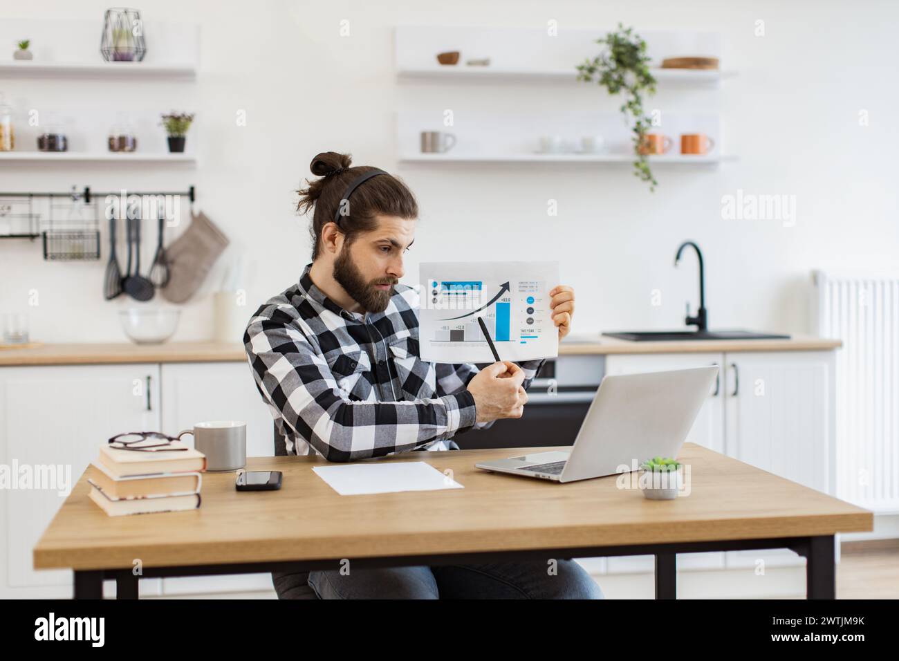 Caucasian worker providing statistical analysis using modern technologies. Stock Photo