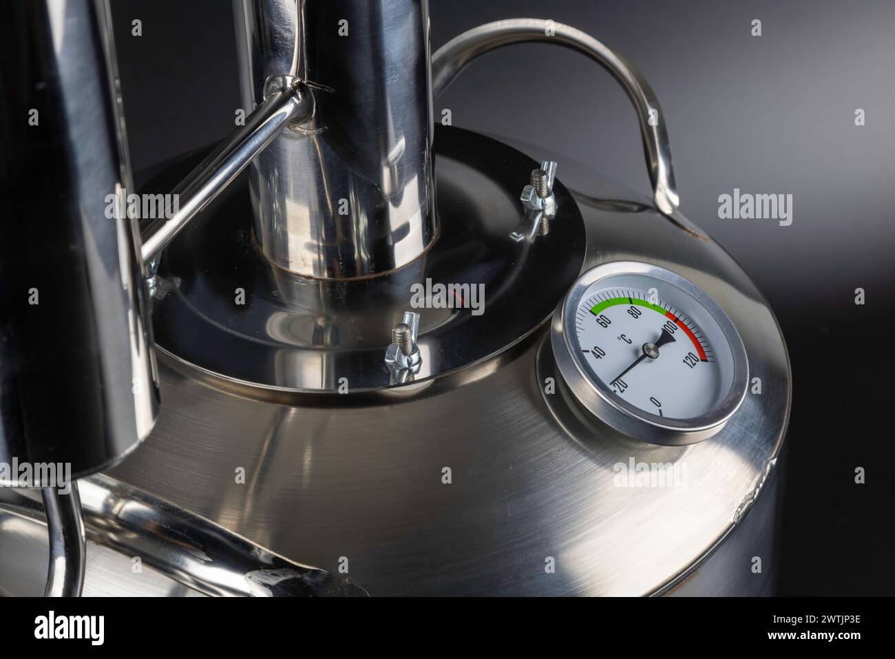 brand new stainless steel alcohol machine on black background Stock ...