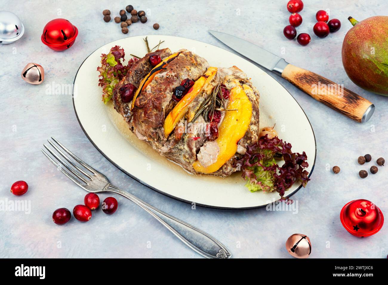 Christmas food. Meat roll baked with aromatic mango pieces. Classic meatloaf on a plate. Stock Photo