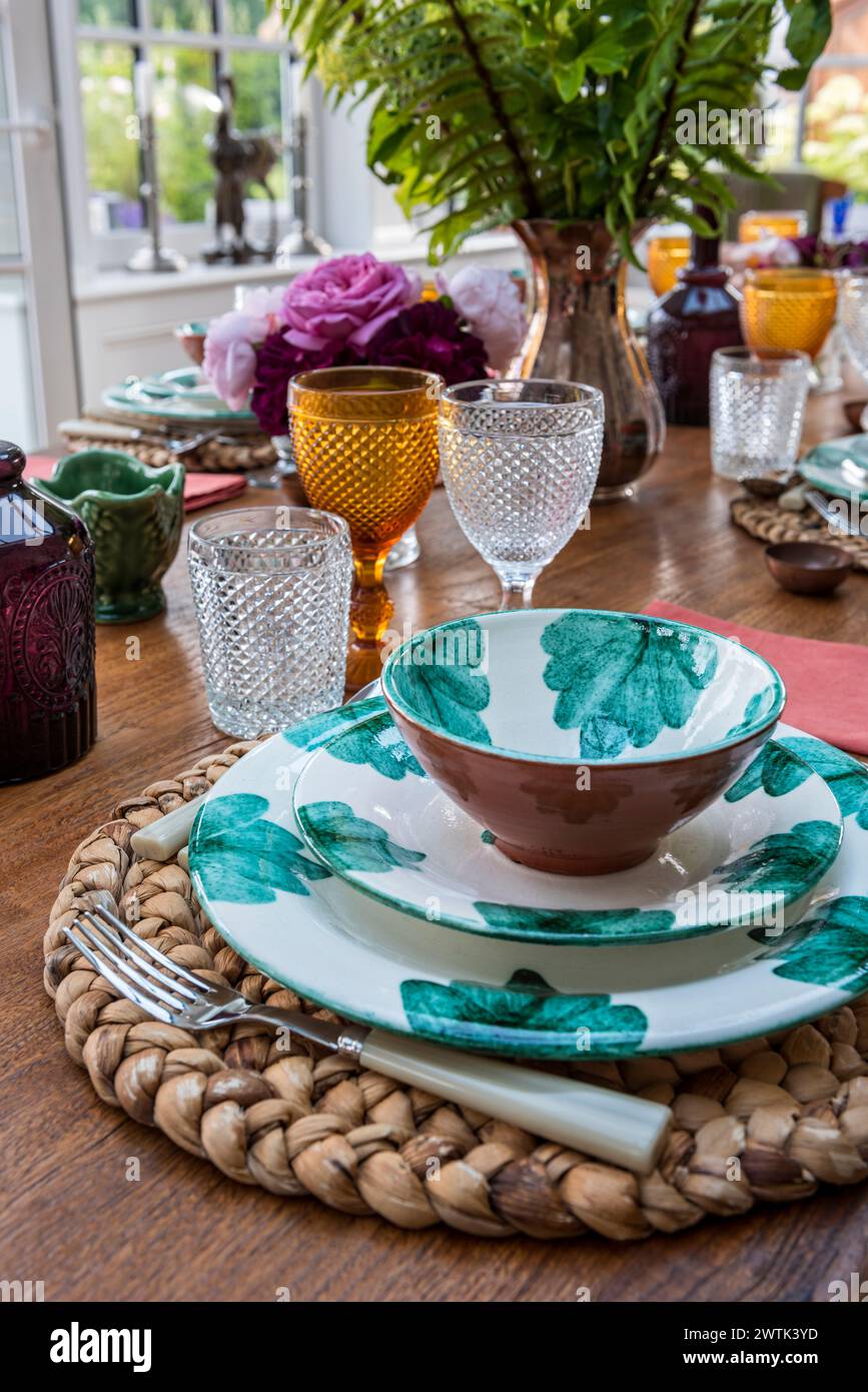 Co-ordinated tableware with glasses on table in Irish home in Greystones, County Wicklow, Ireland Stock Photo