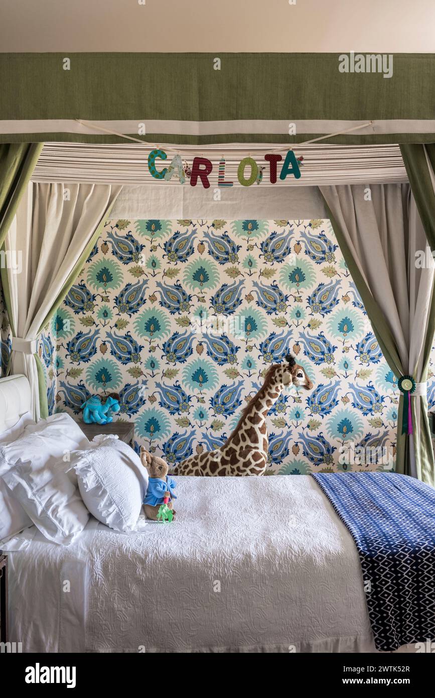 Toy giraffe in girls bedrrom with patterned wallpaper, Greystones, County Wicklow, Ireland Stock Photo