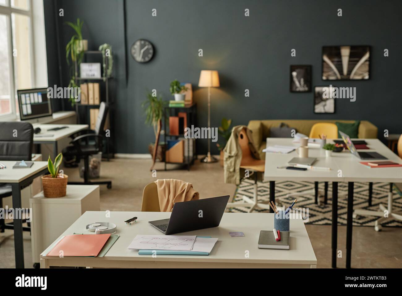 Wide angle view at empty office interior with lived in and cluttered ...