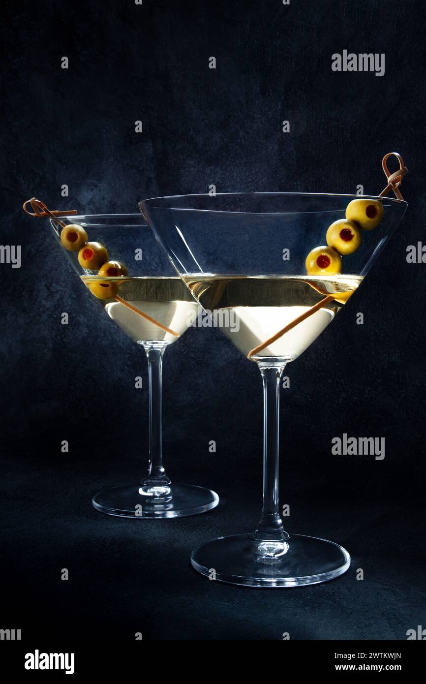 Martini. Two glasses of dirty martini cocktails with vermouth and olives, side view with copy space Stock Photo