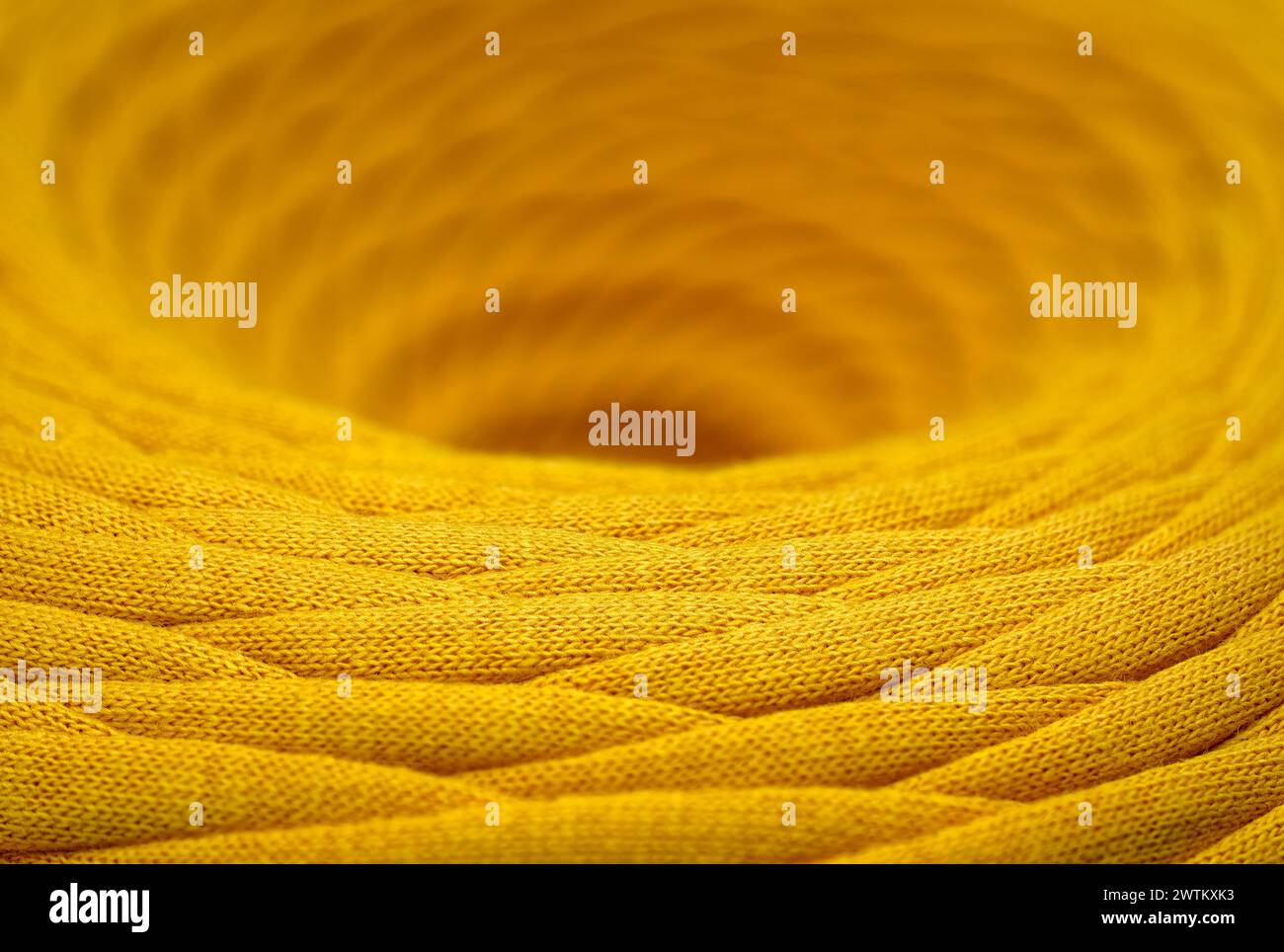 Skein of yellow braided synthetic cord, close-up shot, selective focus, abstract textile industry background Stock Photo