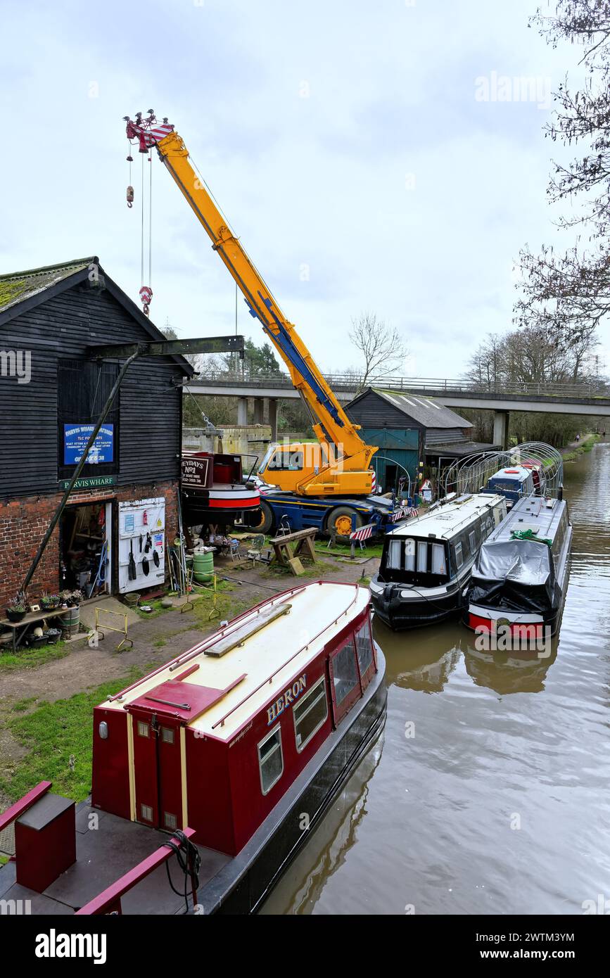 The Parvis Wharf Boatyard with a large lifting crane on the River Wey Navigation canal West Byfleet Surrey England UK Stock Photo