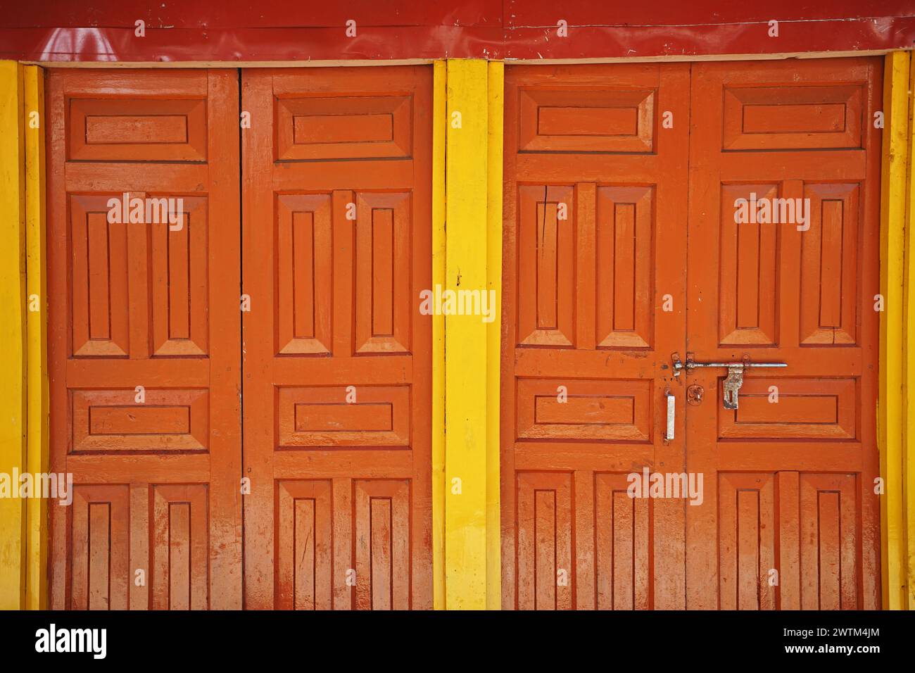Details and design of ancient wooden orange and yellow door Stock Photo