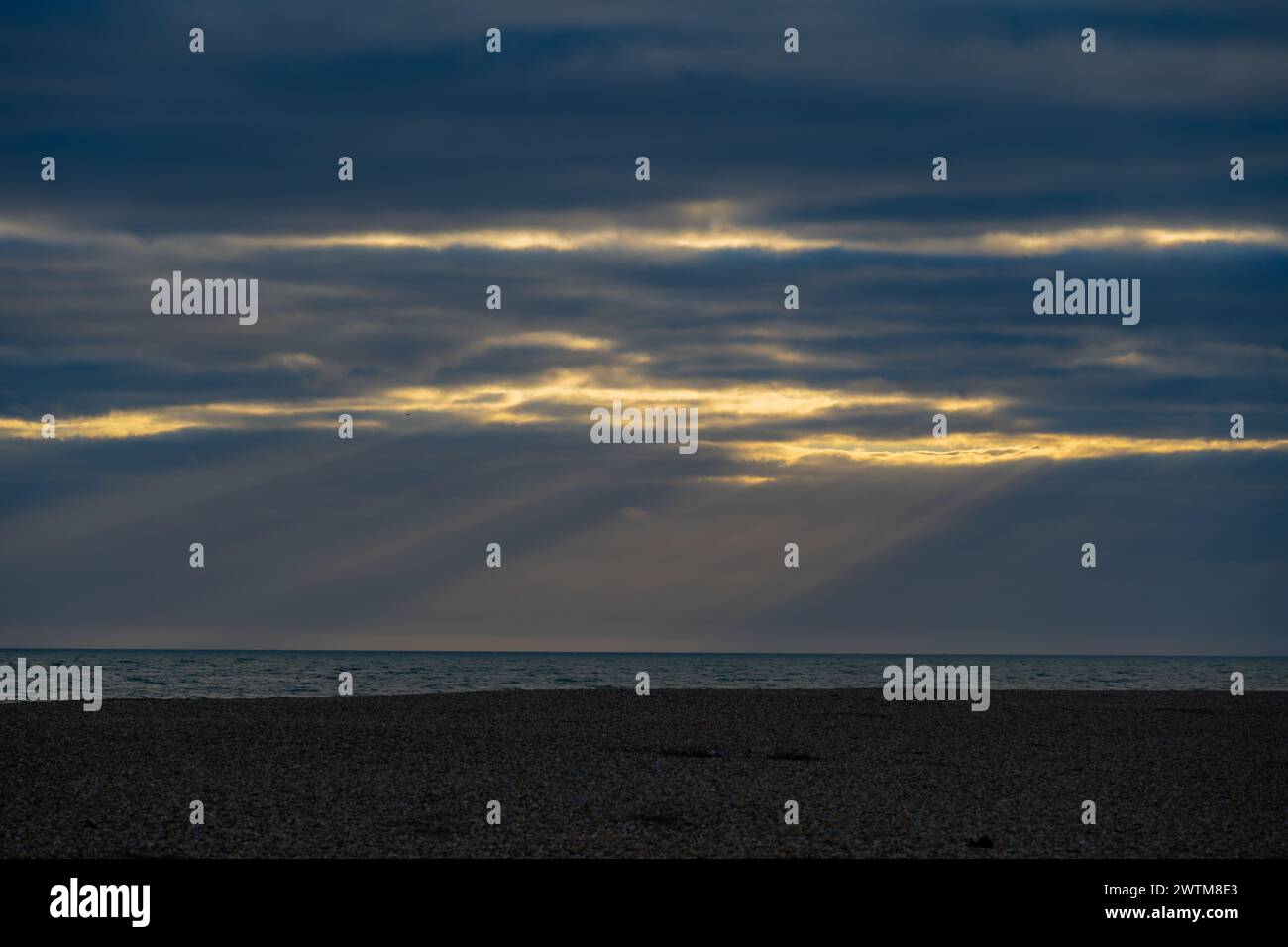 Sunbeams behind storm clouds at Dungeness Stock Photo