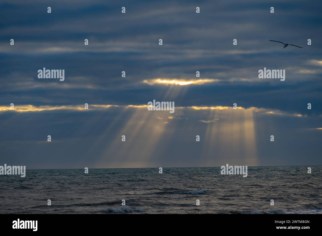 Sunbeams behind storm clouds at Dungeness Stock Photo