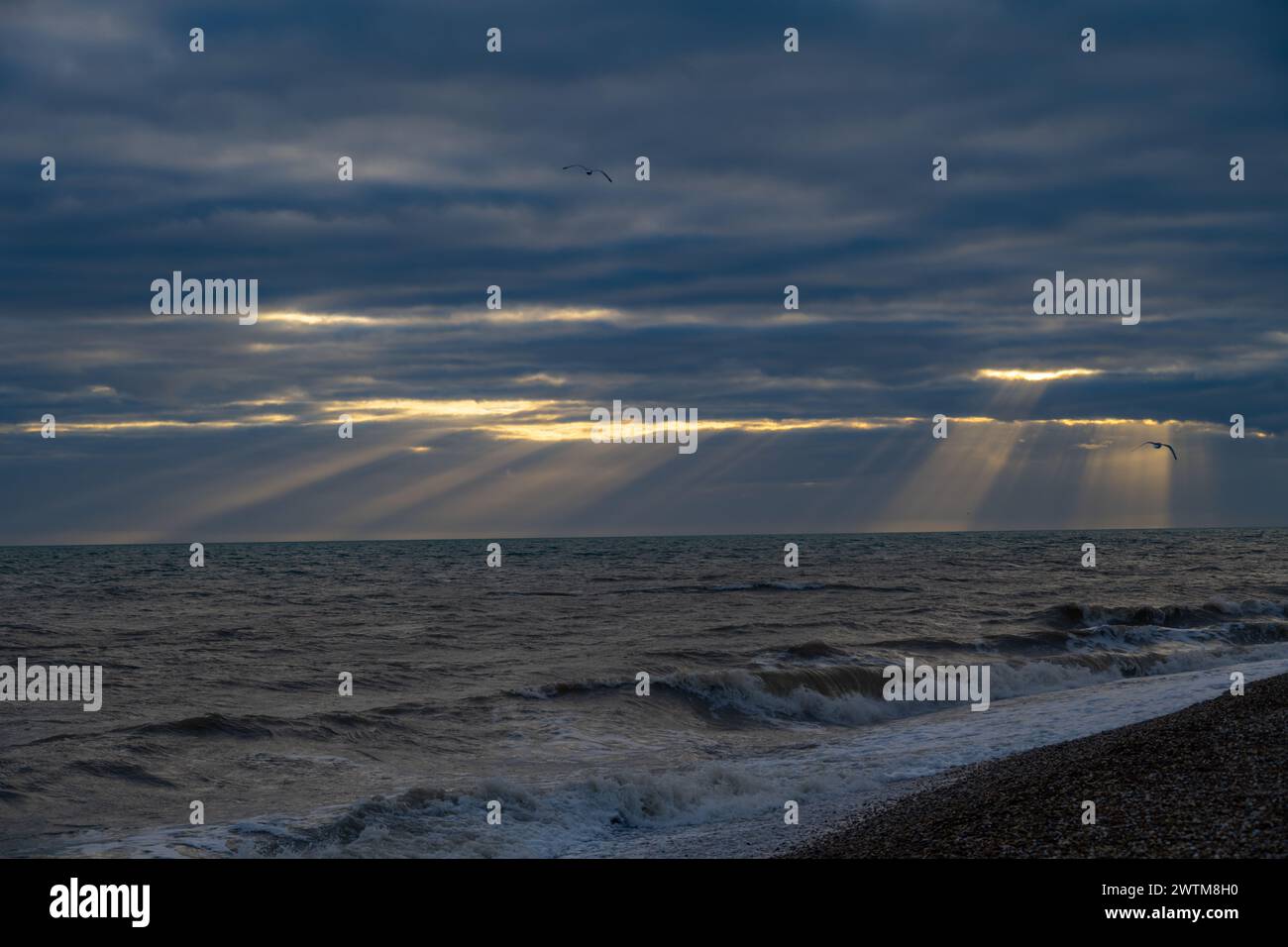 Sunbeams behind storm clouds at Dungeness Stock Photo