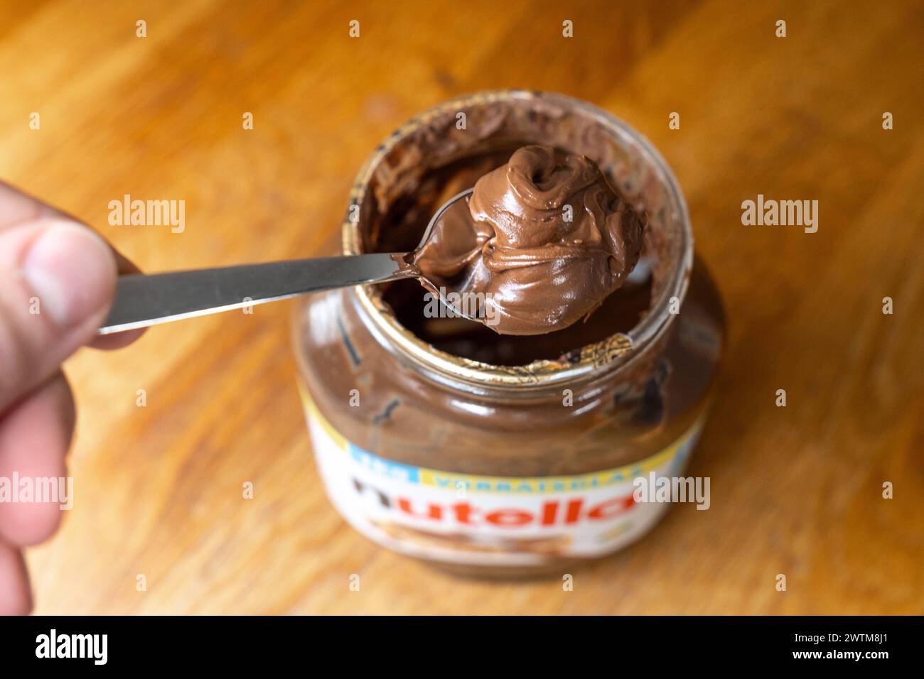 Bavaria, Germany - March 17, 2024: A man takes a spoonful of Nutella ...