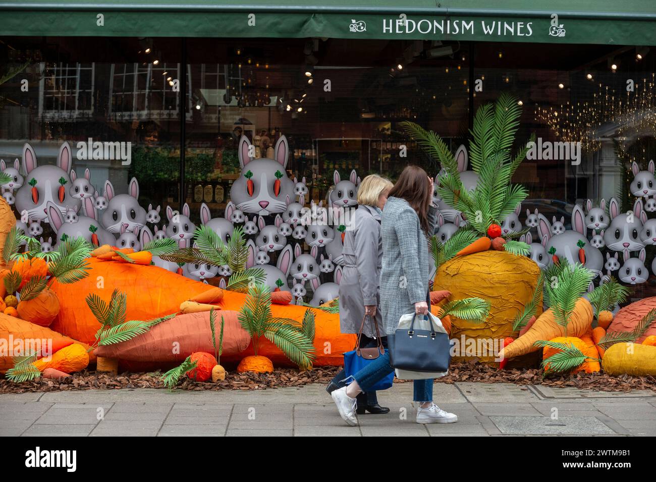London, UK. 18 March 2024. People pass the exterior of Hedonism Wines ...
