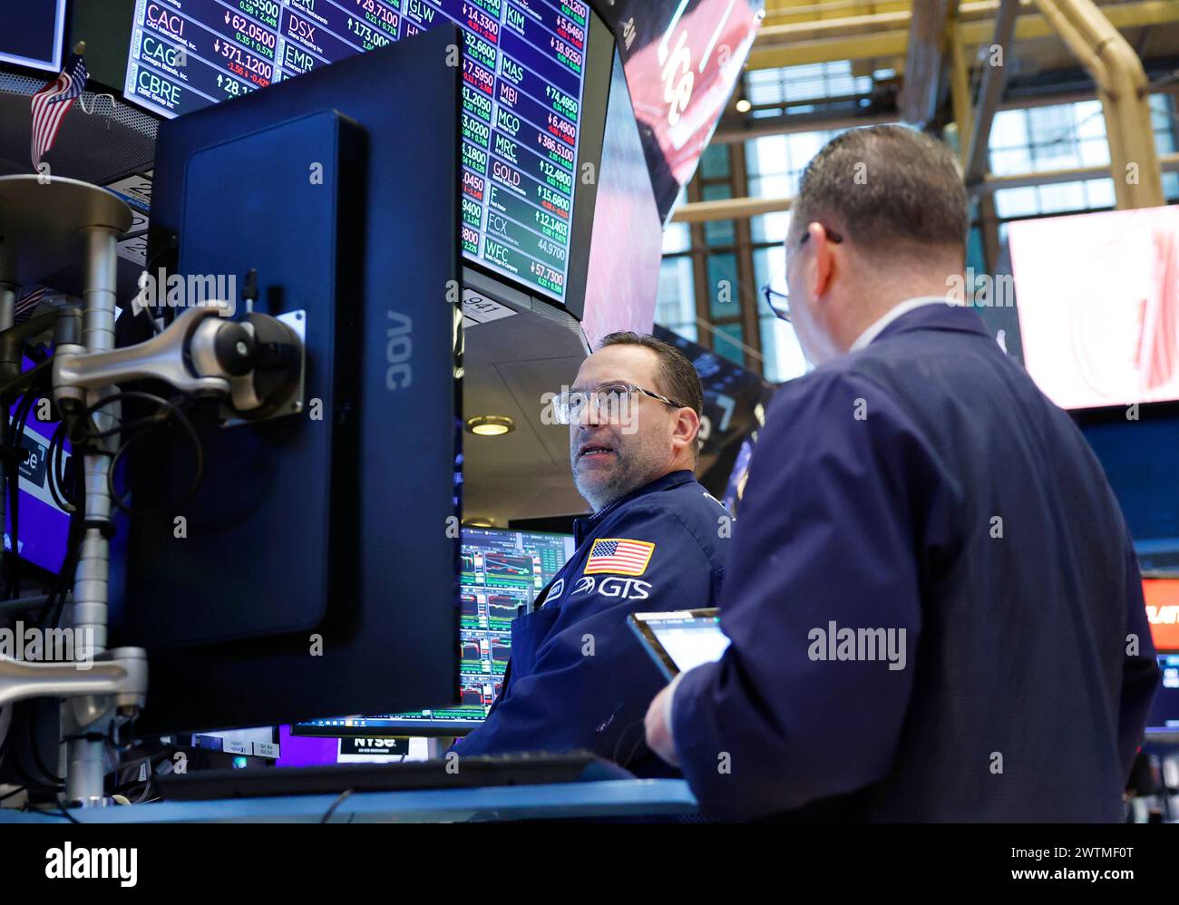 New York, United States. 17th Mar, 2024. Traders work on the floor of ...