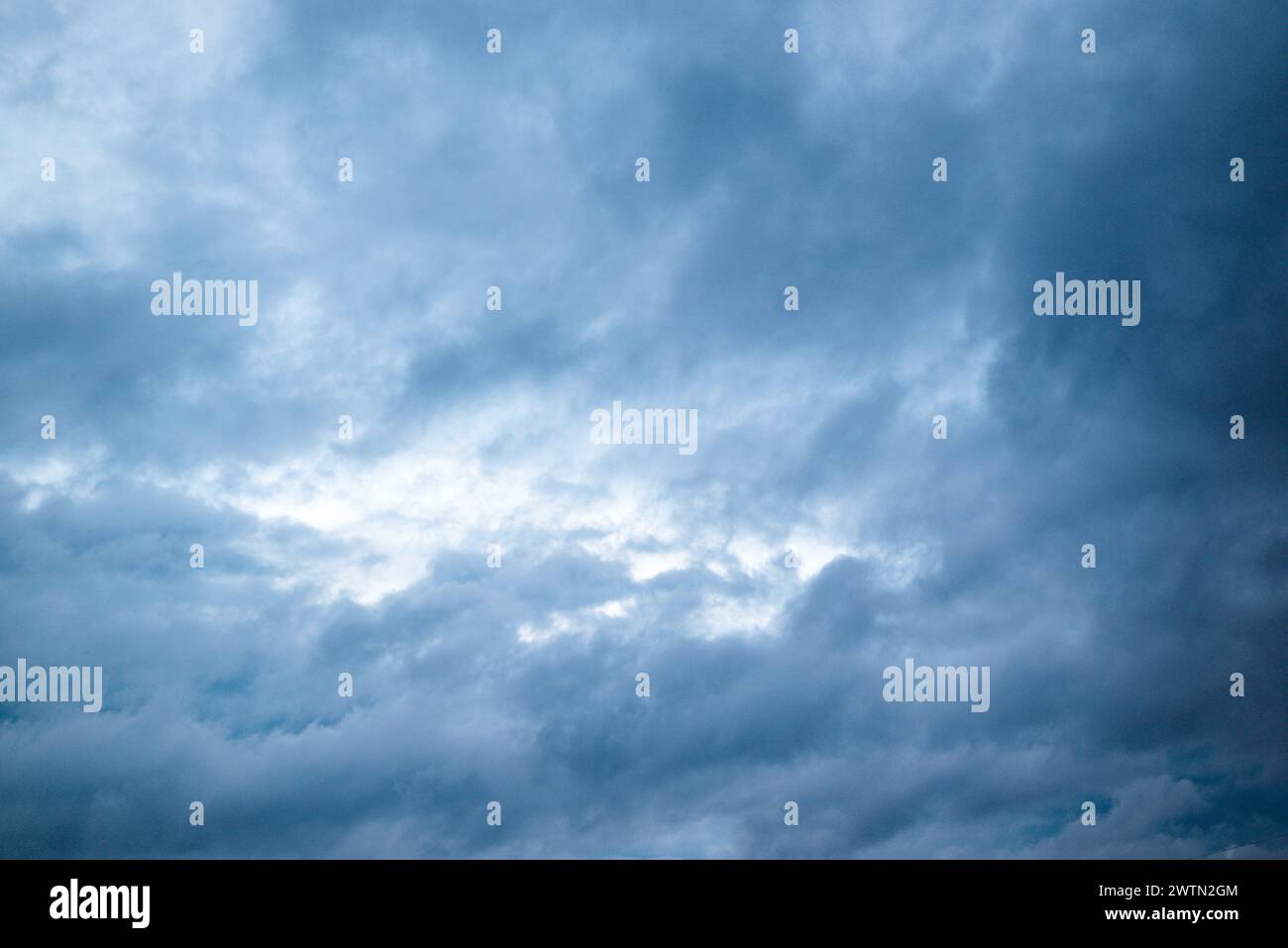 Black cloud and thunderstorm before rainy, Dramatic blue clouds and dark sky. Stock Photo