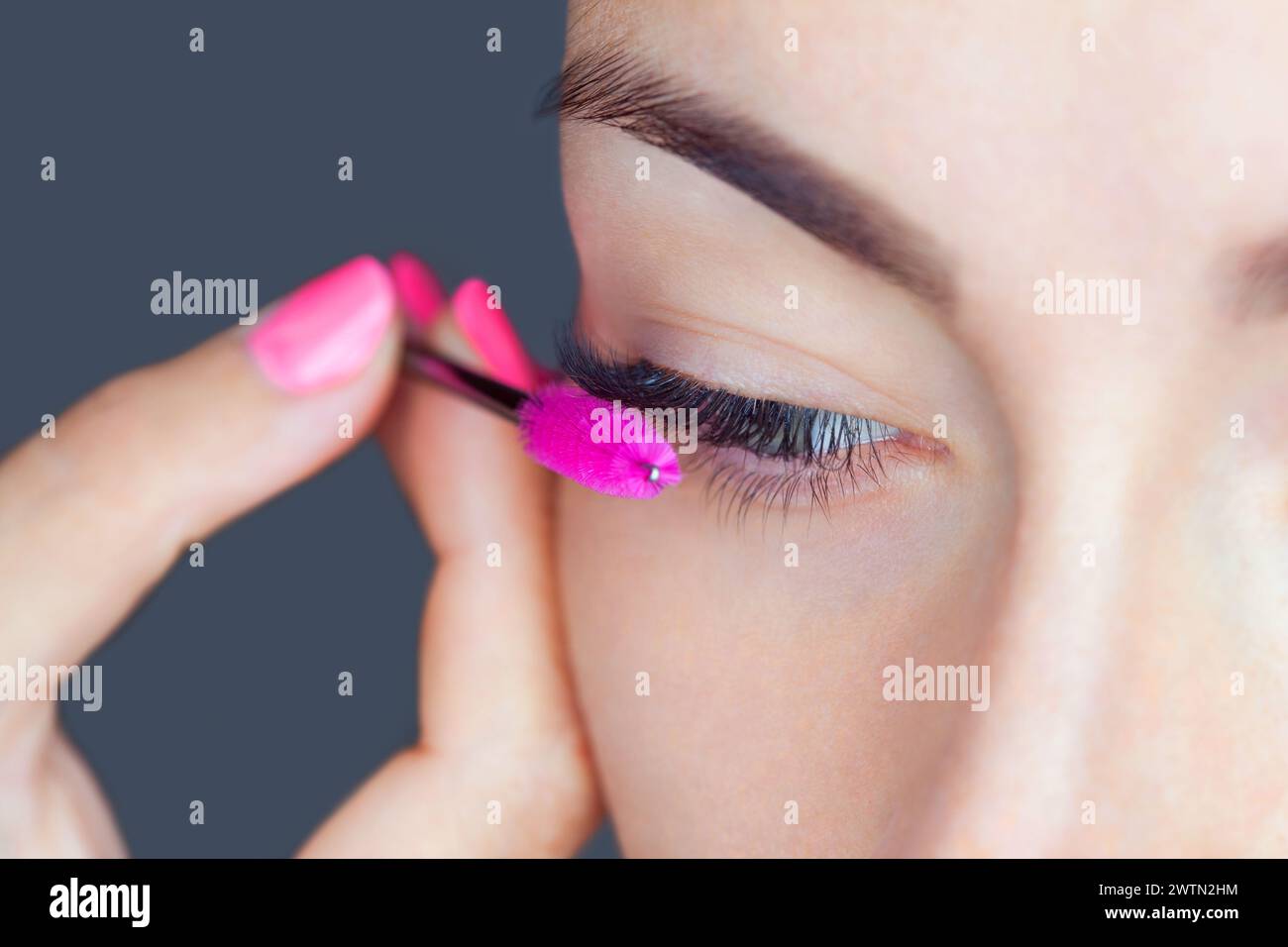 Beautiful Woman with long eyelashes in a beauty salon. Eyelash extension procedure. Lashes close up Stock Photo