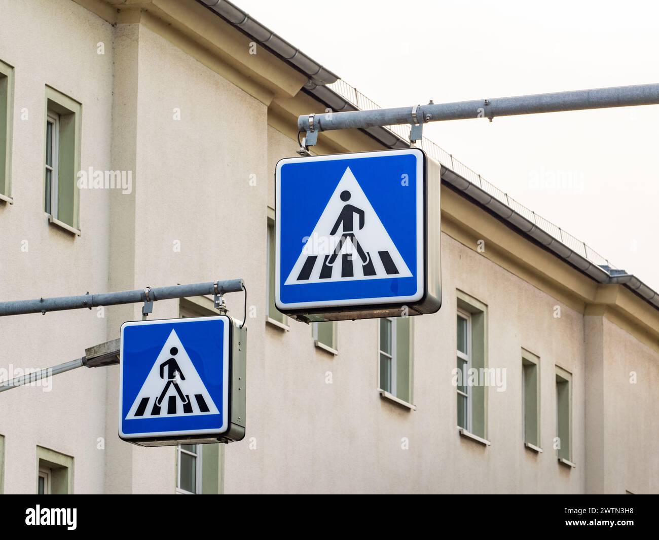 Pedestrian crossing sign in Germany. The signage is next to a zebra ...