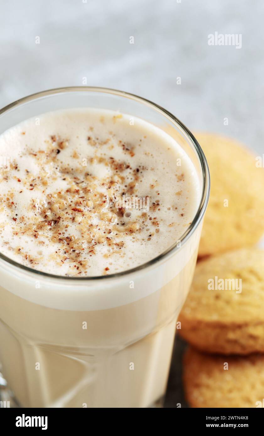 coffee with milk and grated nut in a glass close-up. Raff coffee. Stock Photo
