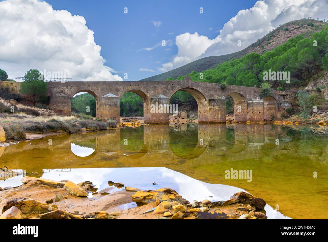 Roman bridge in the hiking route of the water mills along the Odiel river from Sotiel Coronada, in Huelva province, Andalusia, Spain Stock Photo