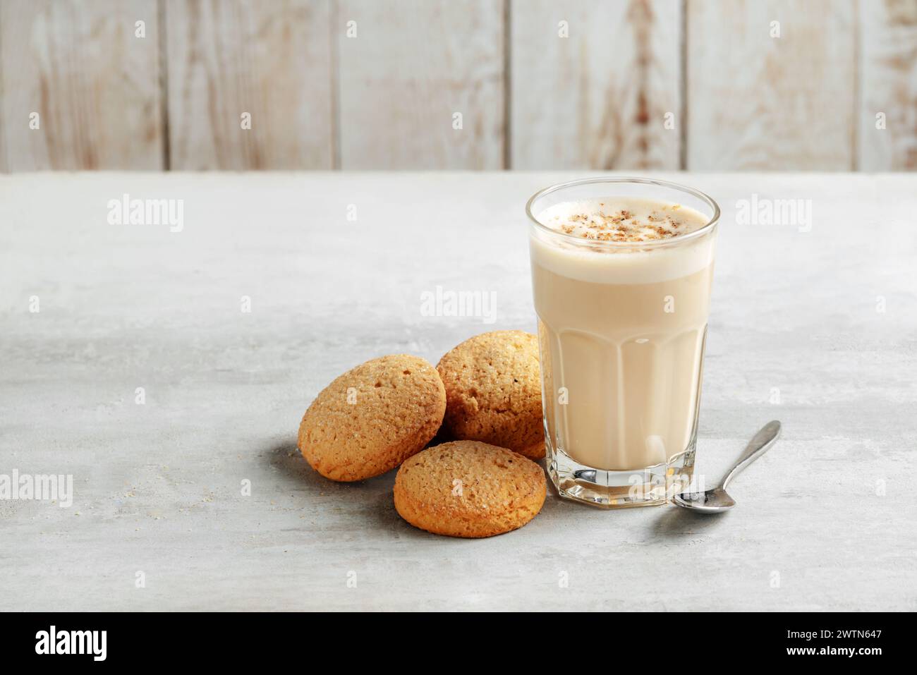 coffee raff in a glass close-up with homemade cookies. coffee with milk and grated nut on light background Stock Photo