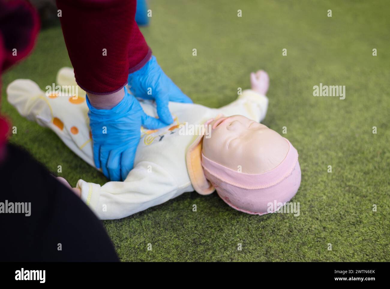 CPR training on an infant training manikin. Stock Photo