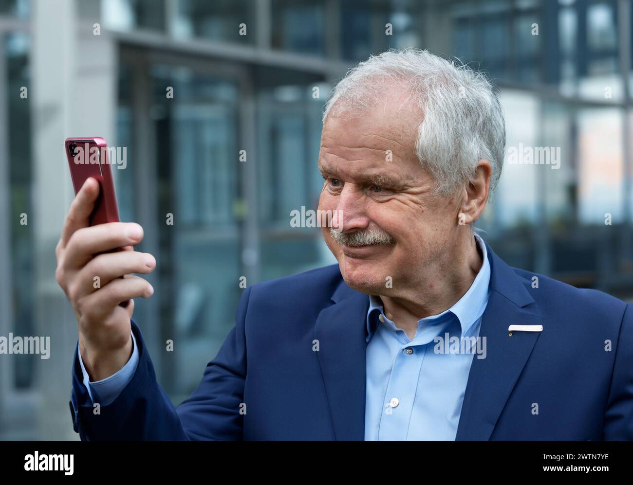 Senior business man looking with a confident smile at his phone. Stock Photo