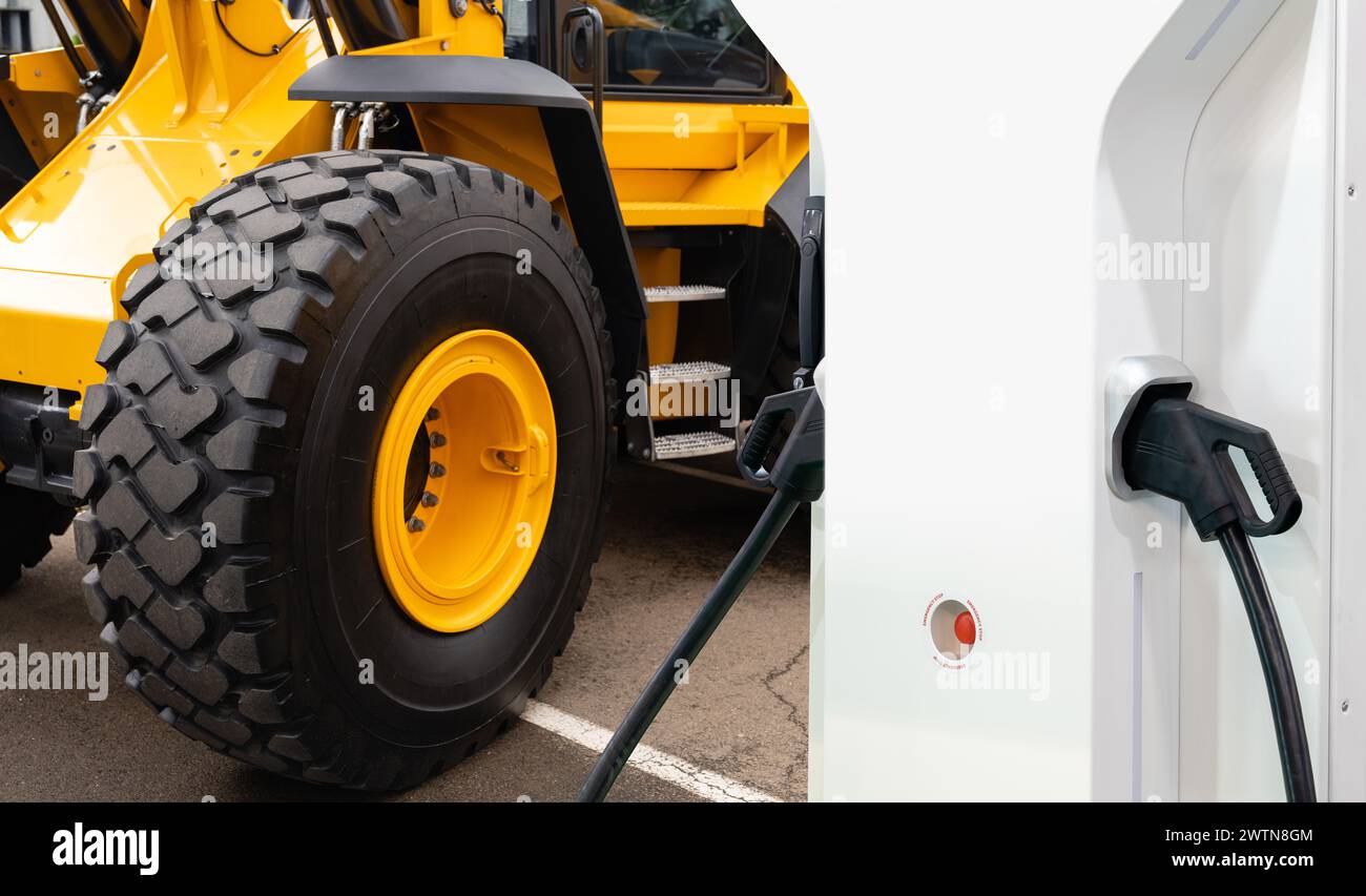Electric construction machines with charging station. Concept Stock ...