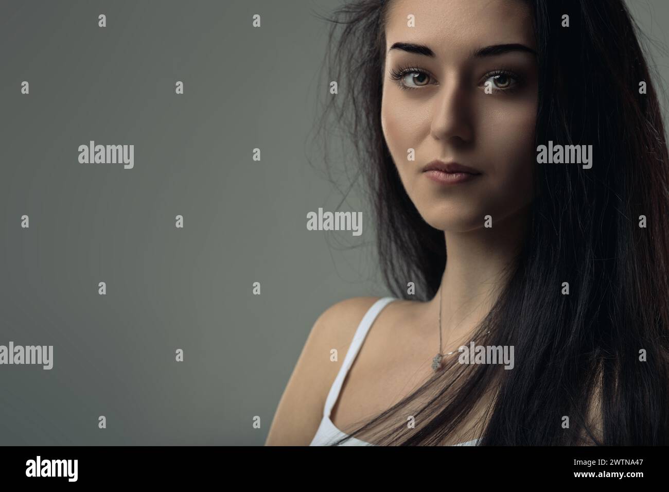 Subtle shadowing highlights her thoughtful expression and fine features Stock Photo