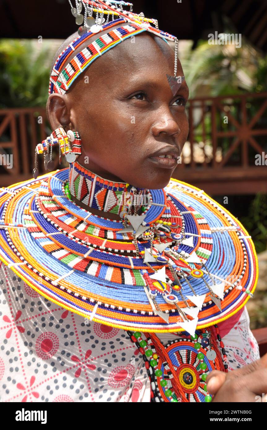 Beautifull Masai Women with tradition colour glass perls around her neck. Hübsche Masai-Frau mit traditionellem Glasperlenschmuck, Halsringe Stock Photo