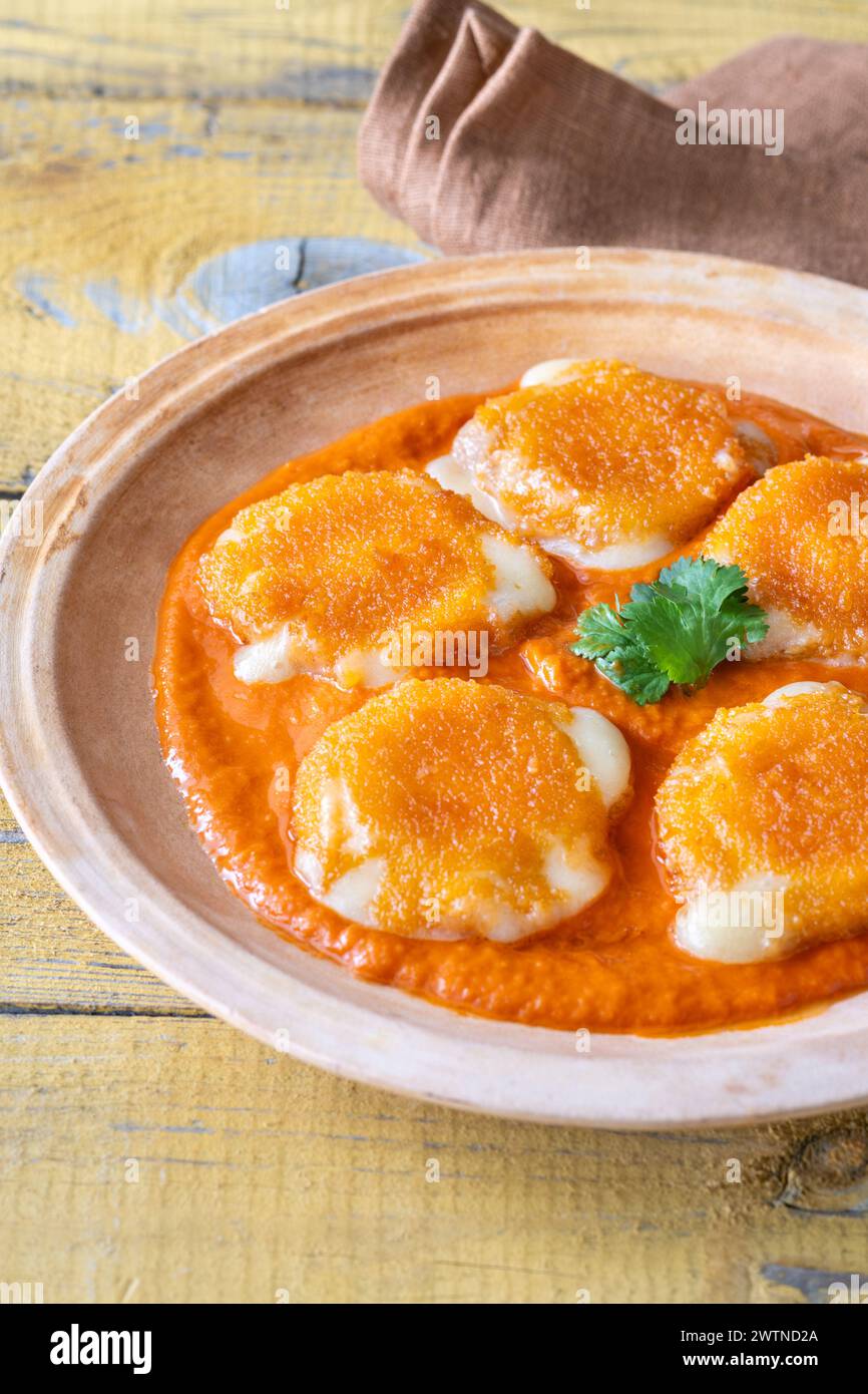 Nuggets with melted camembert with bell pepper sauce Stock Photo