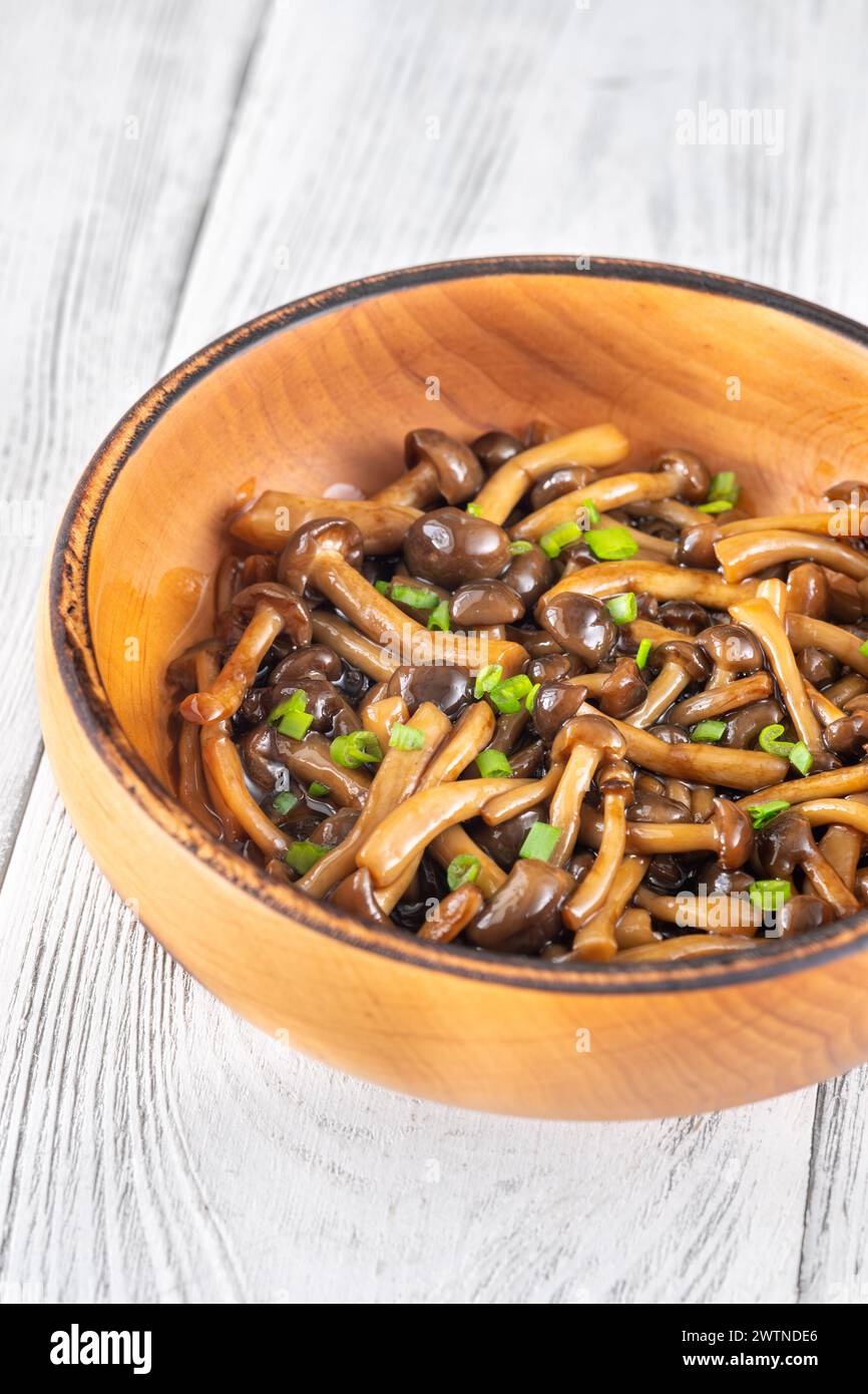 Wooden bowl of cooked brown beach mushrooms Stock Photo