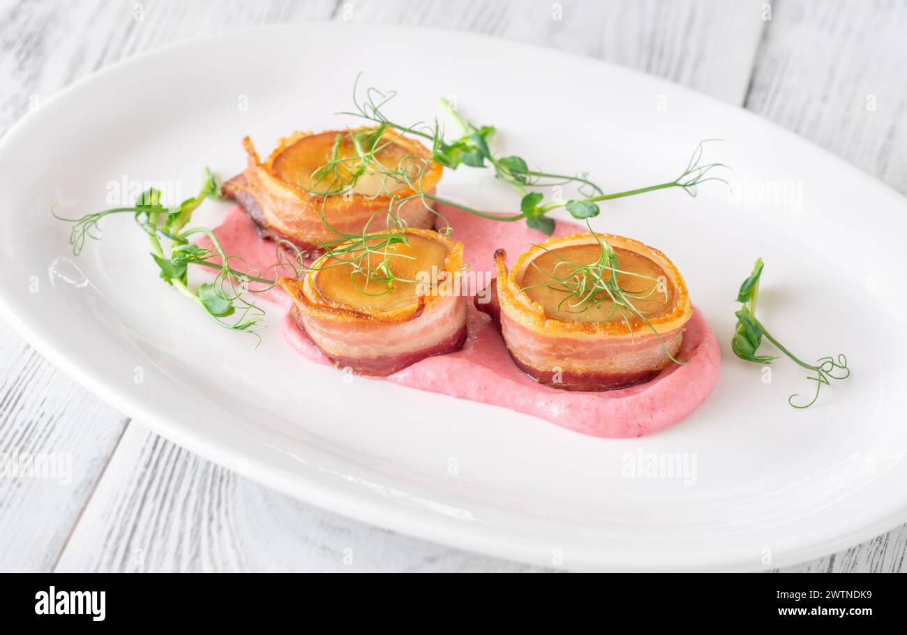 Eryngii mushroom scallpos wrapped in bacon with cream cheese beetroot sauce Stock Photo