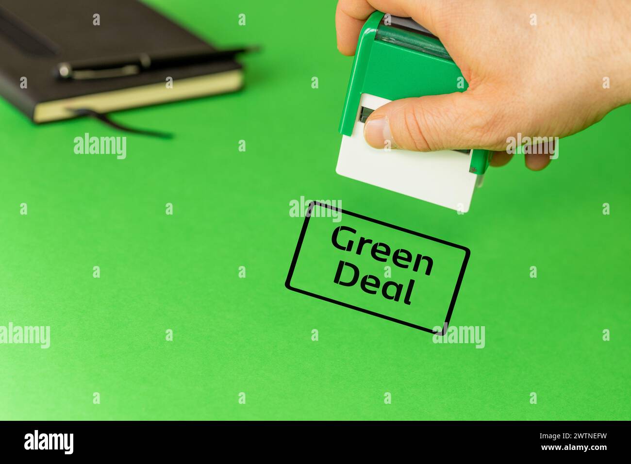 Green deal, European green deal environmental concept, Clerk puts an approving stamp with the words Green deal, copy space Stock Photo