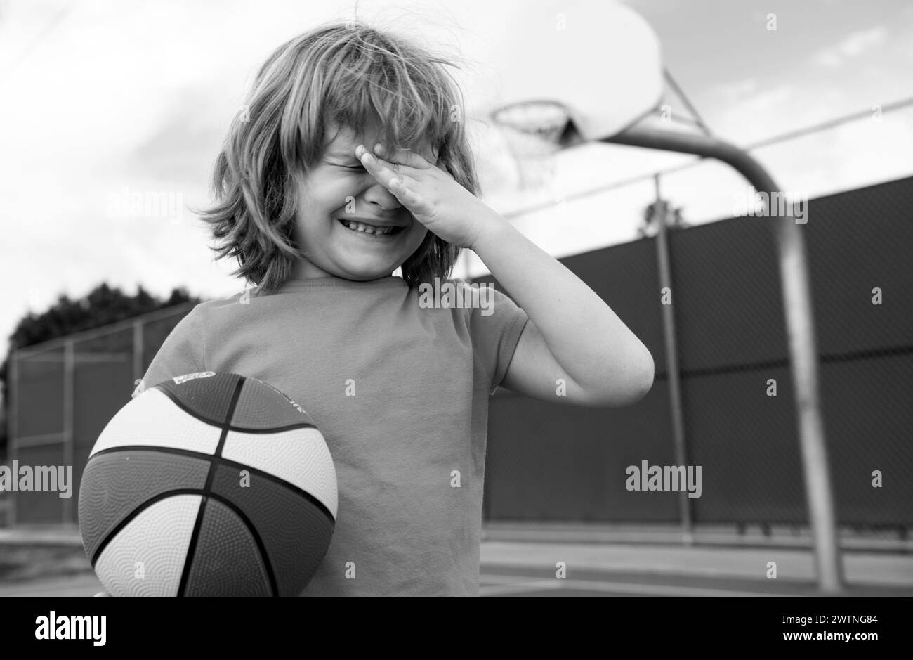 Little boy alone, lonely with ball. Loneliness kids. Boy cries of resentment and grief. Sad child boy portrait. Stock Photo