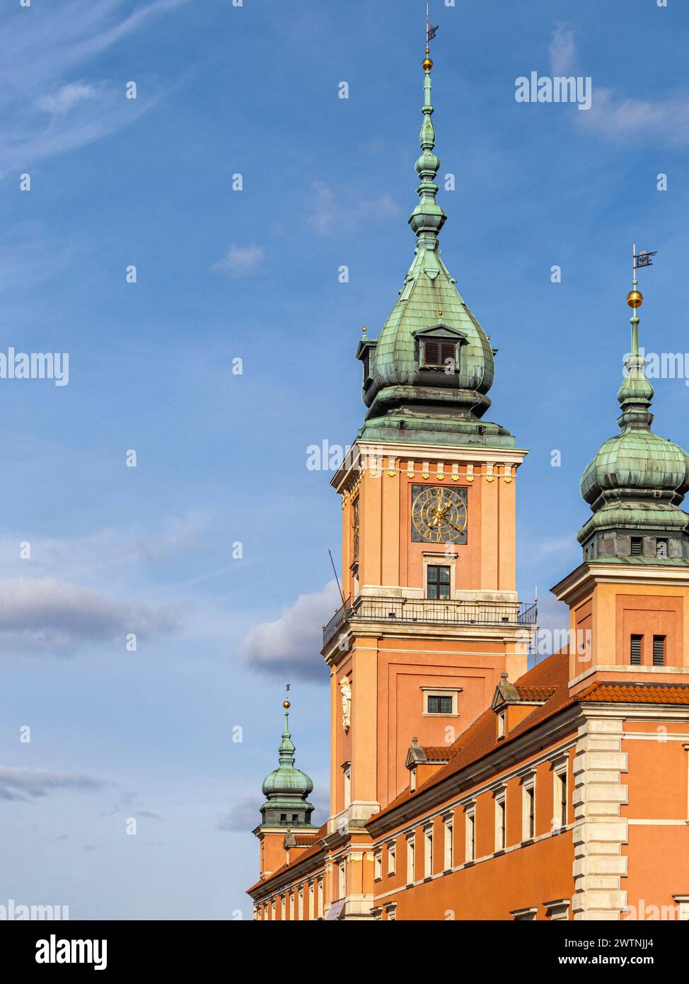 The clock tower of the Royal Castle in Warsaw against a blue sky with white clouds. Stock Photo