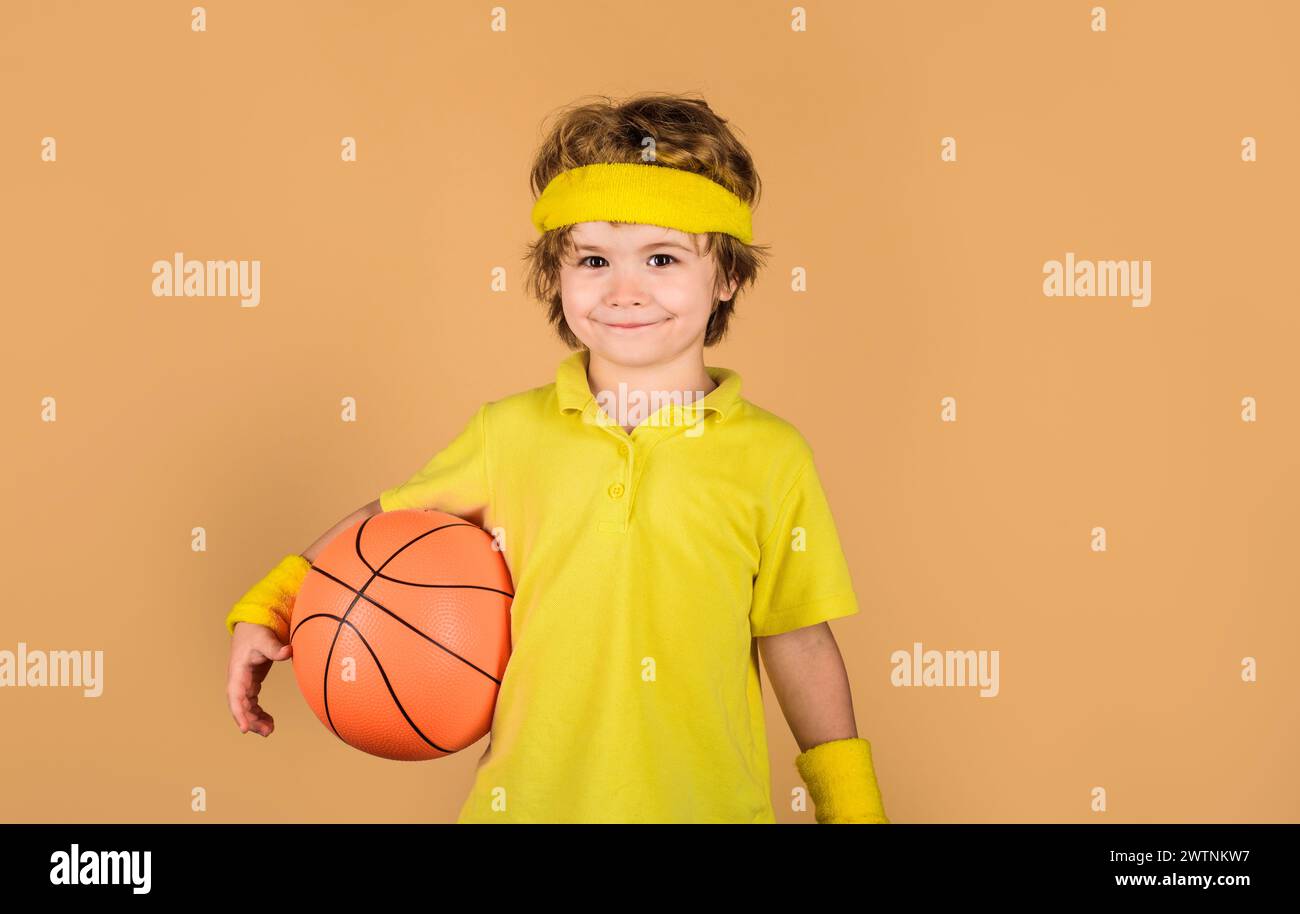 Sport for children. Little basketball player in sports uniform with ball. Hobby sport concept. Fitness, training and healthy lifestyle. Cute sporty Stock Photo