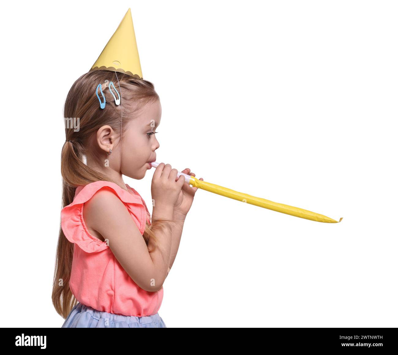Birthday celebration. Cute little girl in party hat with blower on ...